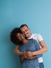 Image showing multiethnic couple laughing and hugging