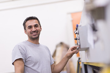 Image showing worker in a factory of wooden furniture