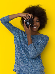 Image showing young african american girl taking photo on a retro camera