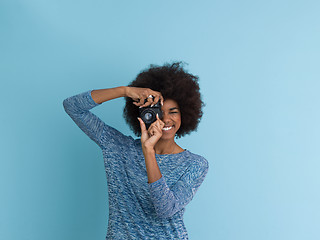 Image showing african american girl taking photo on a retro camera