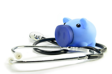 Image showing Stethoscope and piggy bank