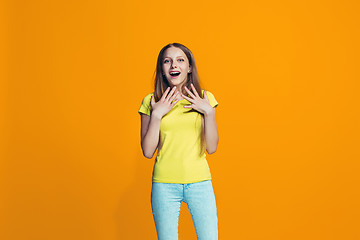 Image showing Beautiful teen girl looking suprised isolated on orange