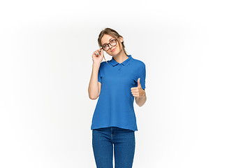 Image showing Closeup of young woman\'s body in empty blue t-shirt isolated on white background. Mock up for disign concept