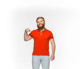 Image showing Closeup of young man\'s body in empty red t-shirt isolated on white background. Mock up for disign concept