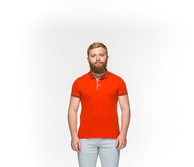 Image showing Closeup of young man\'s body in empty red t-shirt isolated on white background. Mock up for disign concept