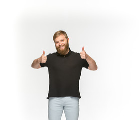 Image showing Closeup of young man\'s body in empty black t-shirt isolated on white background. Mock up for disign concept