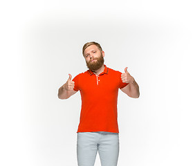 Image showing Closeup of young man\'s body in empty red t-shirt isolated on white background. Mock up for disign concept