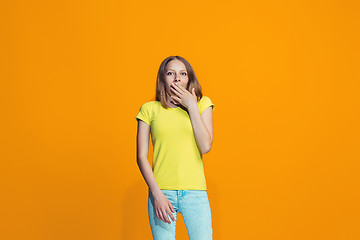 Image showing Beautiful teen girl looking suprised isolated on orange