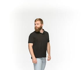 Image showing Closeup of young man\'s body in empty black t-shirt isolated on white background. Mock up for disign concept