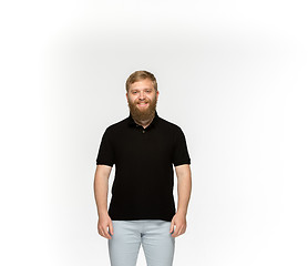 Image showing Closeup of young man\'s body in empty black t-shirt isolated on white background. Mock up for disign concept