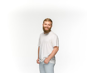 Image showing Closeup of young man\'s body in empty white t-shirt isolated on white background. Mock up for disign concept