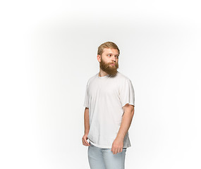 Image showing Closeup of young man\'s body in empty white t-shirt isolated on white background. Mock up for disign concept