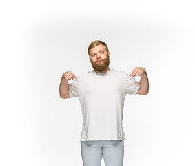 Image showing Closeup of young man\'s body in empty white t-shirt isolated on white background. Mock up for disign concept