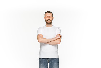 Image showing Closeup of young man\'s body in empty white t-shirt isolated on white background. Mock up for disign concept