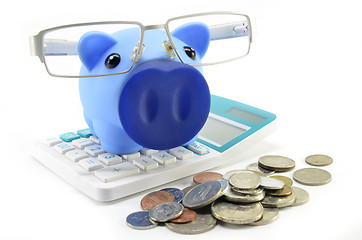Image showing Blue piggybank with coins