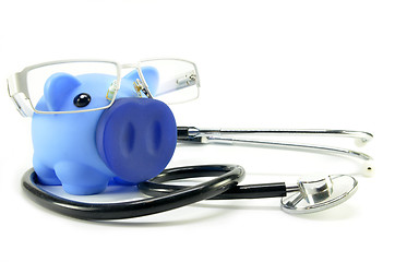 Image showing Stethoscope and piggy bank