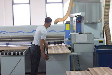 Image showing worker in a factory of wooden furniture