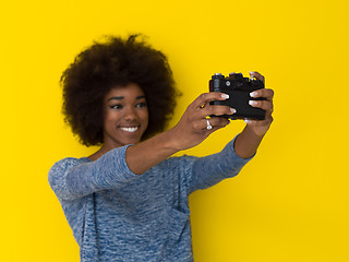 Image showing young african american girl taking photo on a retro camera