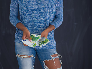 Image showing black woman holding money on gray background