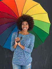 Image showing african american woman holding a colorful umbrella