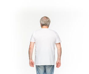 Image showing Closeup of senior man\'s body in empty white t-shirt isolated on white background. Mock up for disign concept