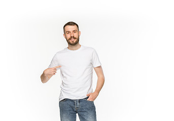 Image showing Closeup of young man\'s body in empty white t-shirt isolated on white background. Mock up for disign concept