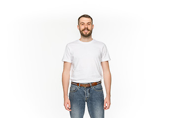 Image showing Closeup of young man\'s body in empty white t-shirt isolated on white background. Mock up for disign concept