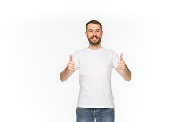 Image showing Closeup of young man\'s body in empty white t-shirt isolated on white background. Mock up for disign concept