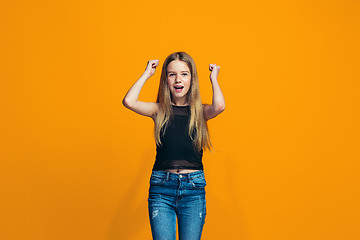 Image showing Happy success teen girl celebrating being a winner. Dynamic energetic image of female model