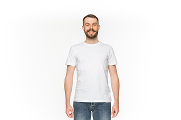 Image showing Closeup of young man\'s body in empty white t-shirt isolated on white background. Mock up for disign concept