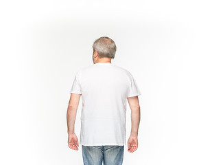 Image showing Closeup of senior man\'s body in empty white t-shirt isolated on white background. Mock up for disign concept