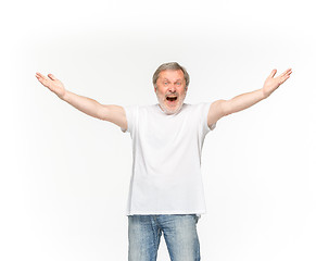 Image showing Closeup of senior man\'s body in empty white t-shirt isolated on white background. Mock up for disign concept