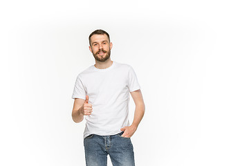 Image showing Closeup of young man\'s body in empty white t-shirt isolated on white background. Mock up for disign concept