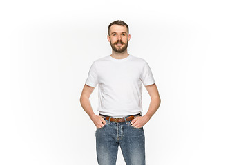 Image showing Closeup of young man\'s body in empty white t-shirt isolated on white background. Mock up for disign concept