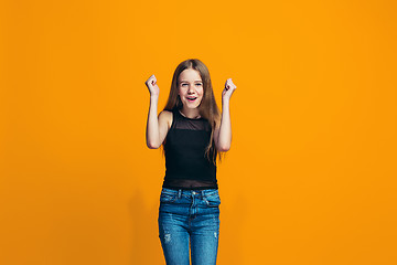 Image showing Happy success teen girl celebrating being a winner. Dynamic energetic image of female model