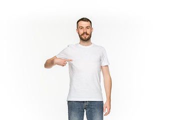 Image showing Closeup of young man\'s body in empty white t-shirt isolated on white background. Mock up for disign concept