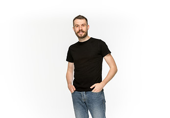 Image showing Closeup of young man\'s body in empty black t-shirt isolated on white background. Mock up for disign concept