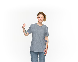 Image showing Closeup of young woman\'s body in empty gray t-shirt isolated on white background. Mock up for disign concept