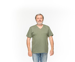 Image showing Closeup of senior man\'s body in empty green t-shirt isolated on white background. Mock up for disign concept