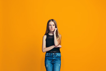 Image showing Young serious thoughtful teen girl. Doubt concept.