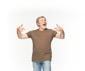 Image showing Closeup of senior man\'s body in empty brown t-shirt isolated on white background. Mock up for disign concept