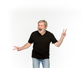 Image showing Closeup of senior man\'s body in empty black t-shirt isolated on white background. Mock up for disign concept