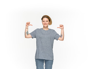 Image showing Closeup of young woman\'s body in empty gray t-shirt isolated on white background. Mock up for disign concept