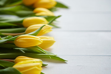 Image showing Composition of fresh tulips placed in row on white rustic wooden table