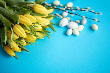 Image showing Holiday contept decoration with easter eggs and yellow tulips ov