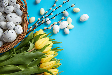 Image showing Holiday contept decoration with easter eggs and yellow tulips ov