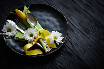 Image showing Easter spring table dishware composition with yellow tulip flower