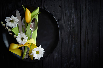 Image showing Easter spring table dishware composition with yellow tulip flower