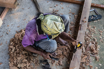 Image showing Carpenter working in traditional manual carpentry shop in a third world country.