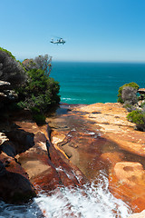 Image showing The army helicopter coming in close to view the waterfalls